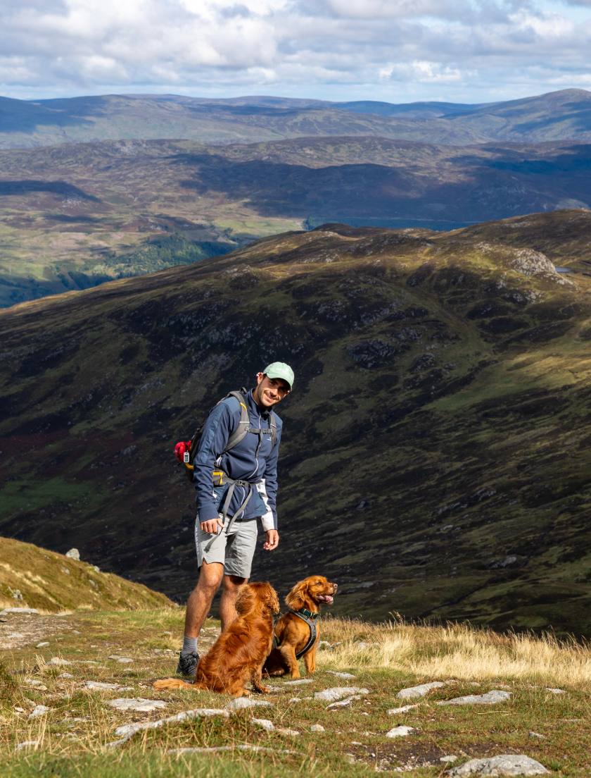 Thomas on a Scottish ridge with his two spaniels