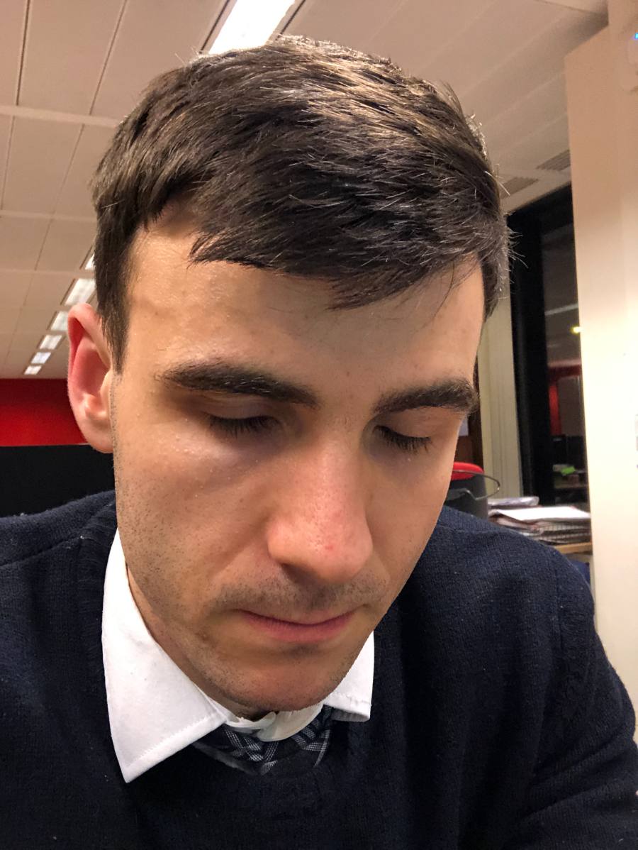 Thomas head-down at his newsroom desk
