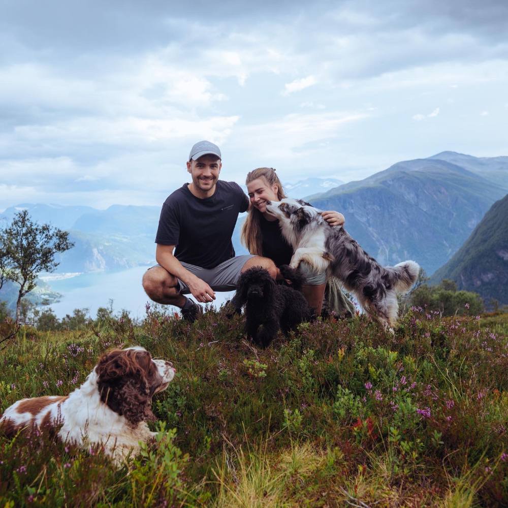 Thomas and Guro with their dogs on a fjord summit in Norway